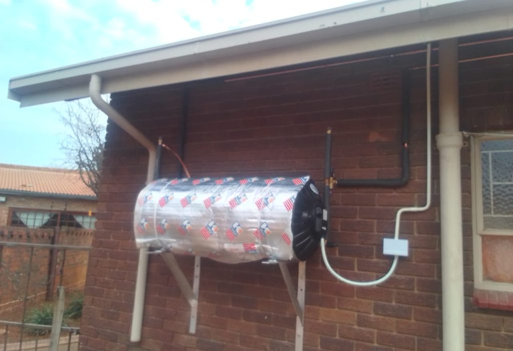 Newly installed geyser on an exterior wall in Centurion, representing professional plumbing services.